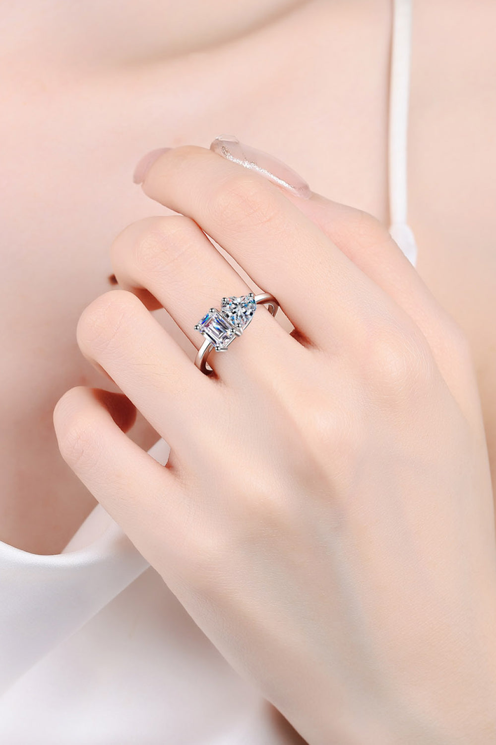 Silver dual-cut moissanite engagement ring with two prominent stones.