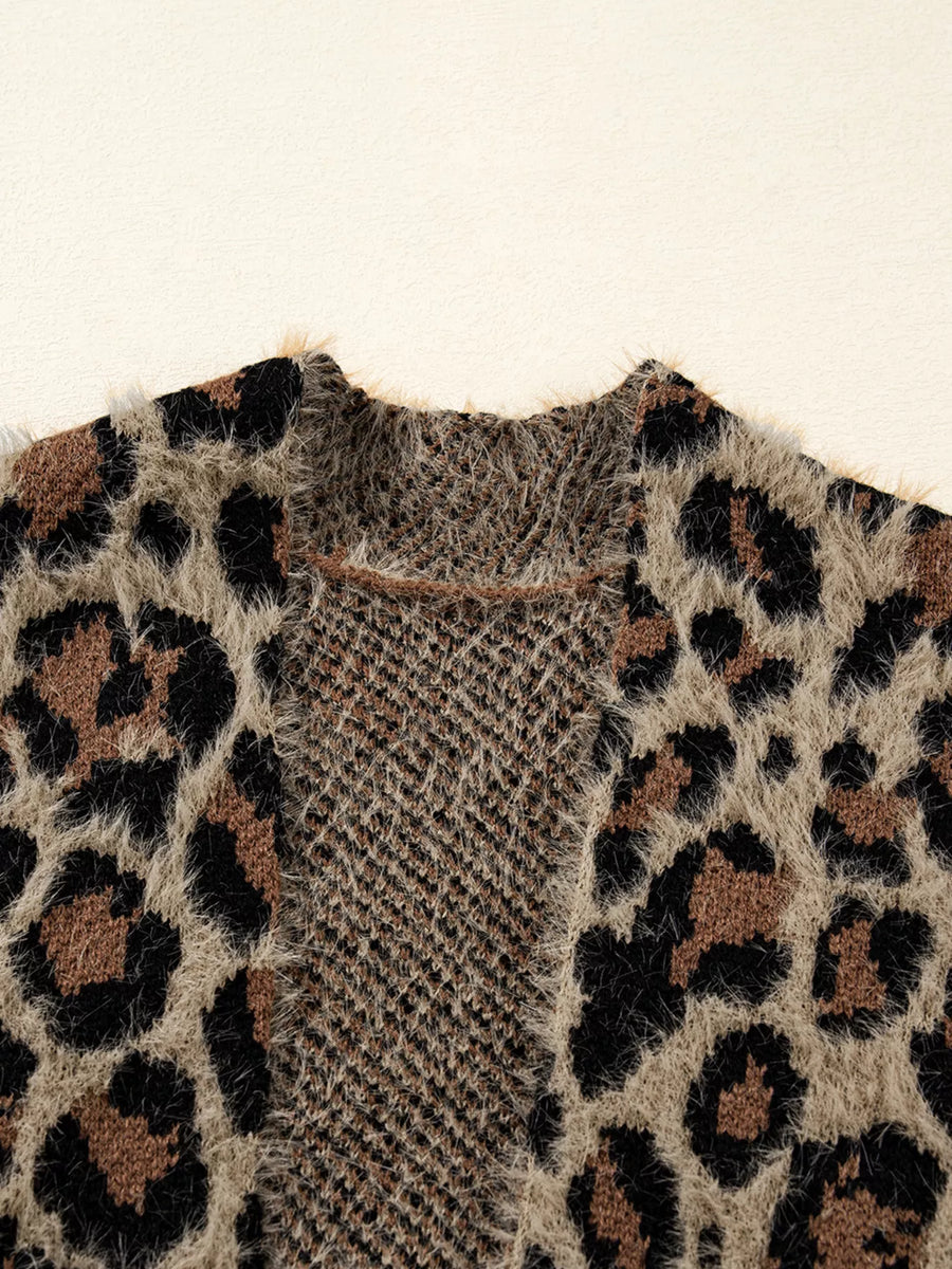 Leopard print fuzzy knit cardigan with a textured yoke and raw edge trim.
