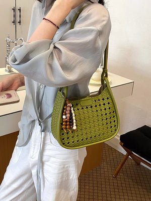 Green shoulder bag featuring woven and geometric