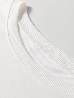 White crewneck loungewear top with ribbed neckline and visible stitching detail.