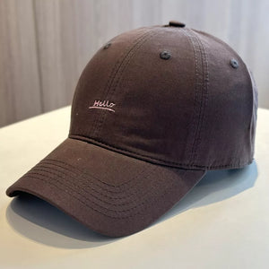 Brown baseball cap with embroidered "Hello" detail.