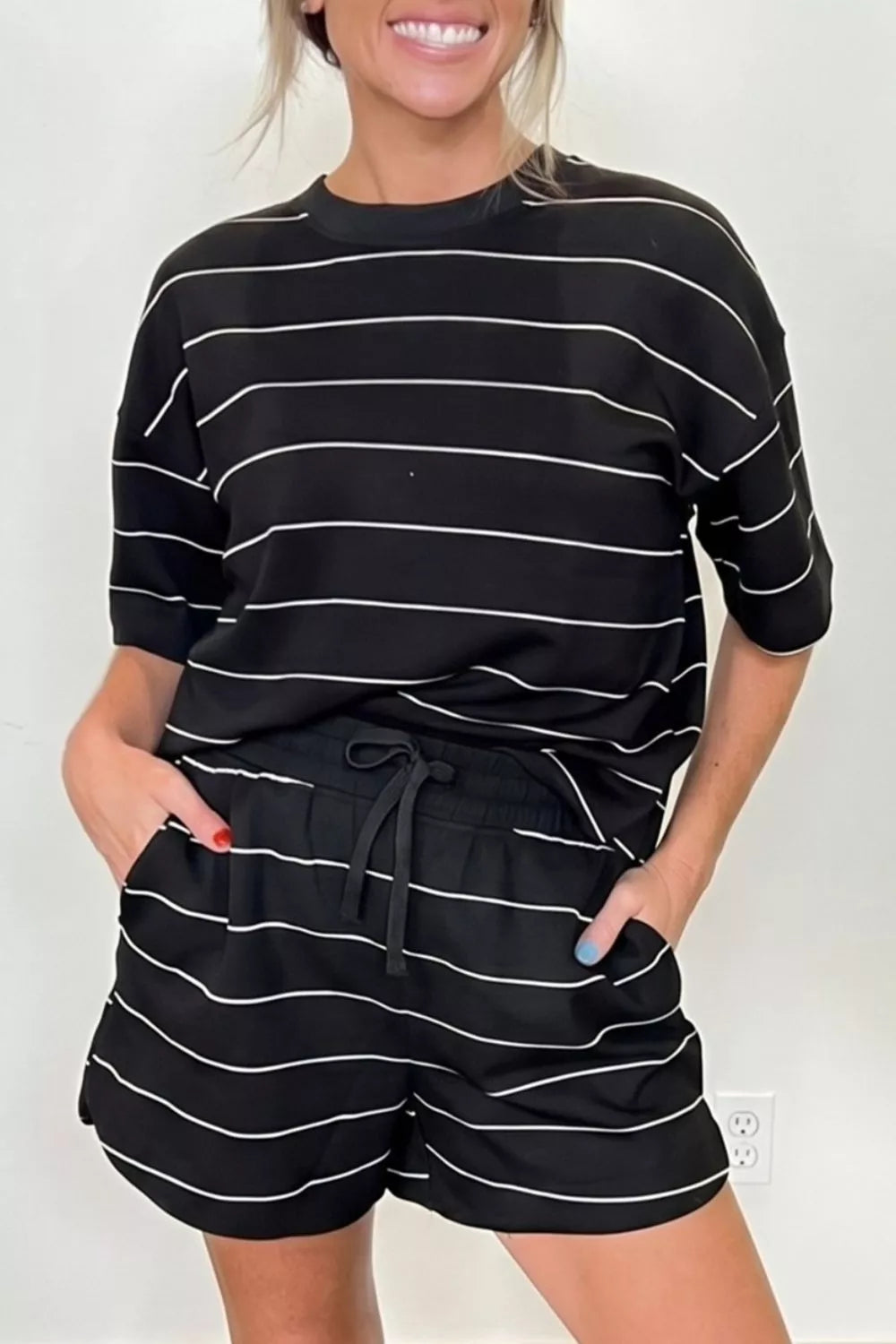 Black and white striped t-shirt and shorts set with drawstring waist.