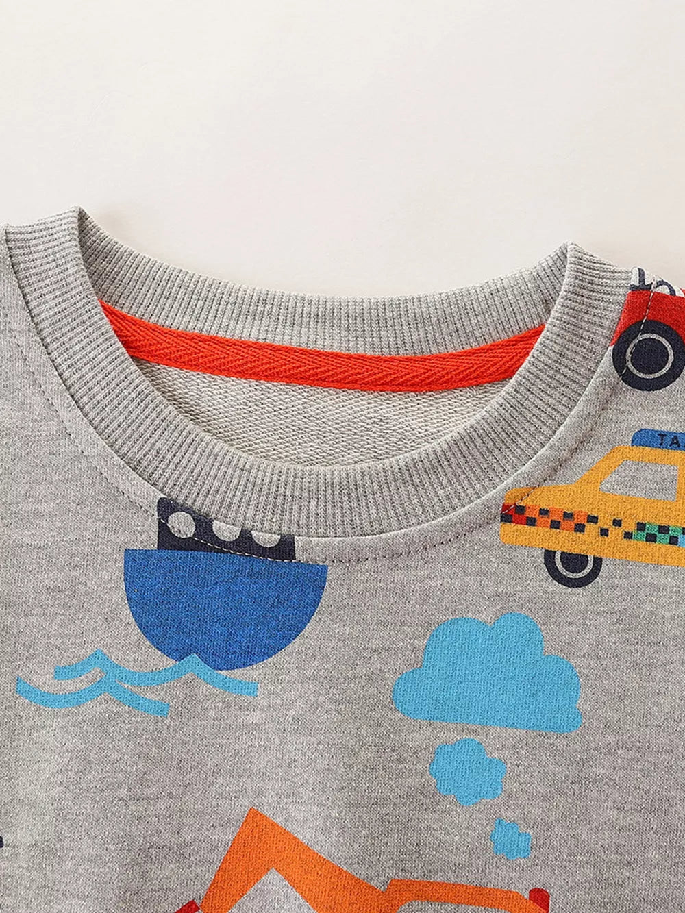 Grey cotton crew neck sweatshirt with playful transportation all-over print and red neck trim.