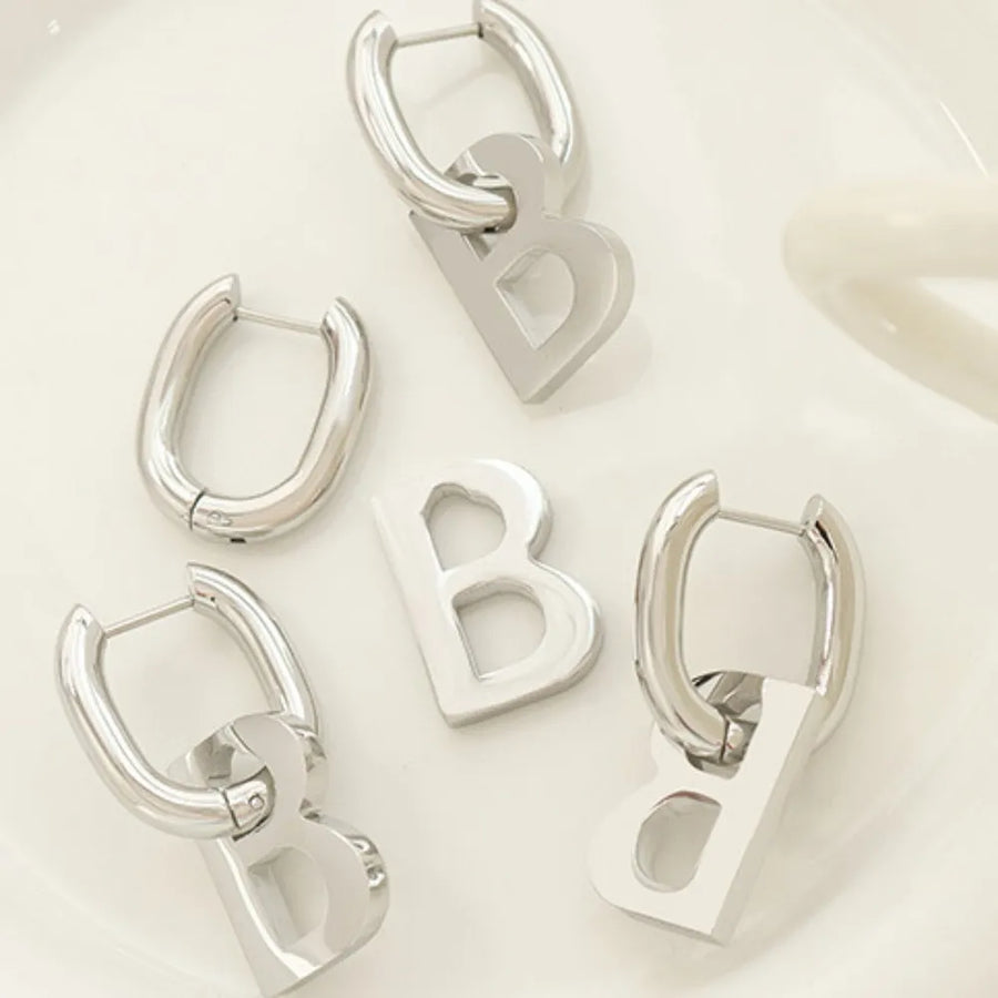 Silver titanium statement hoop earrings with bold letter charms