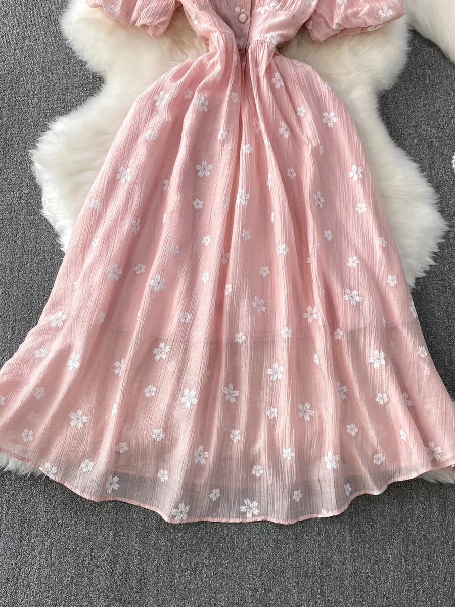 Dusty pink midi dress with puff sleeves, button front, and white floral embroidery.