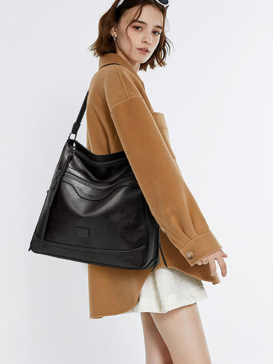 black handbag with medium and zip