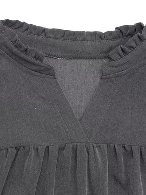 Dark gray cotton blend dress with ruffled neckline and V-neck detail.