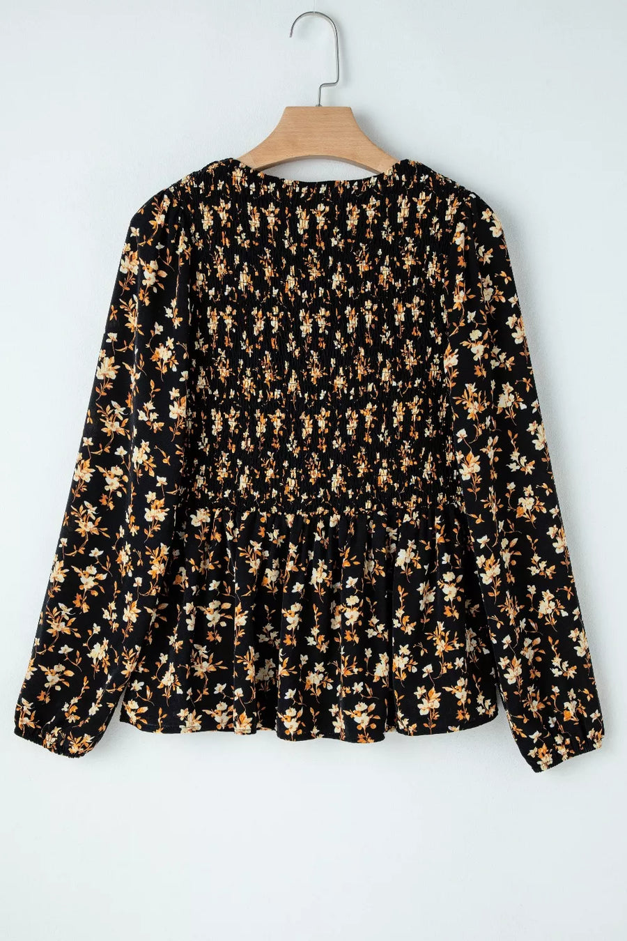 Black floral smocked waist long-sleeve blouse with peplum hem