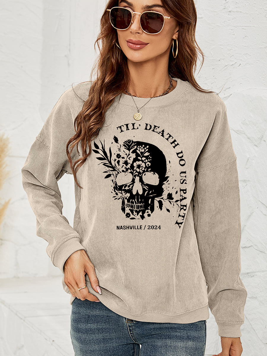 Sand corduroy sweatshirt with a black floral skull graphic and text.