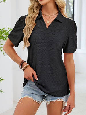 Black eyelet ruched short sleeve blouse with a collared V-neck and puff sleeves.