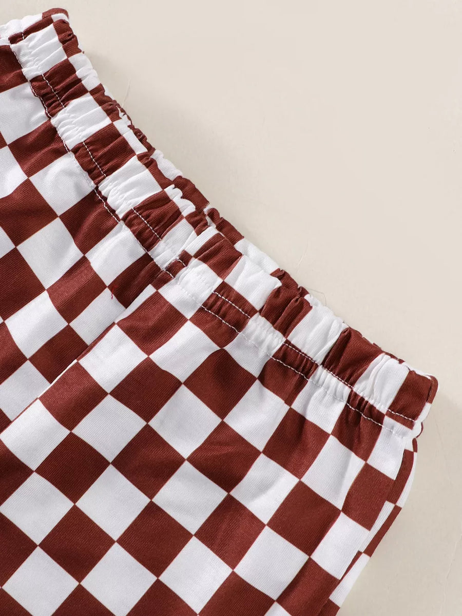 Baby shorts with brown and white checkered pattern and elastic waistband.