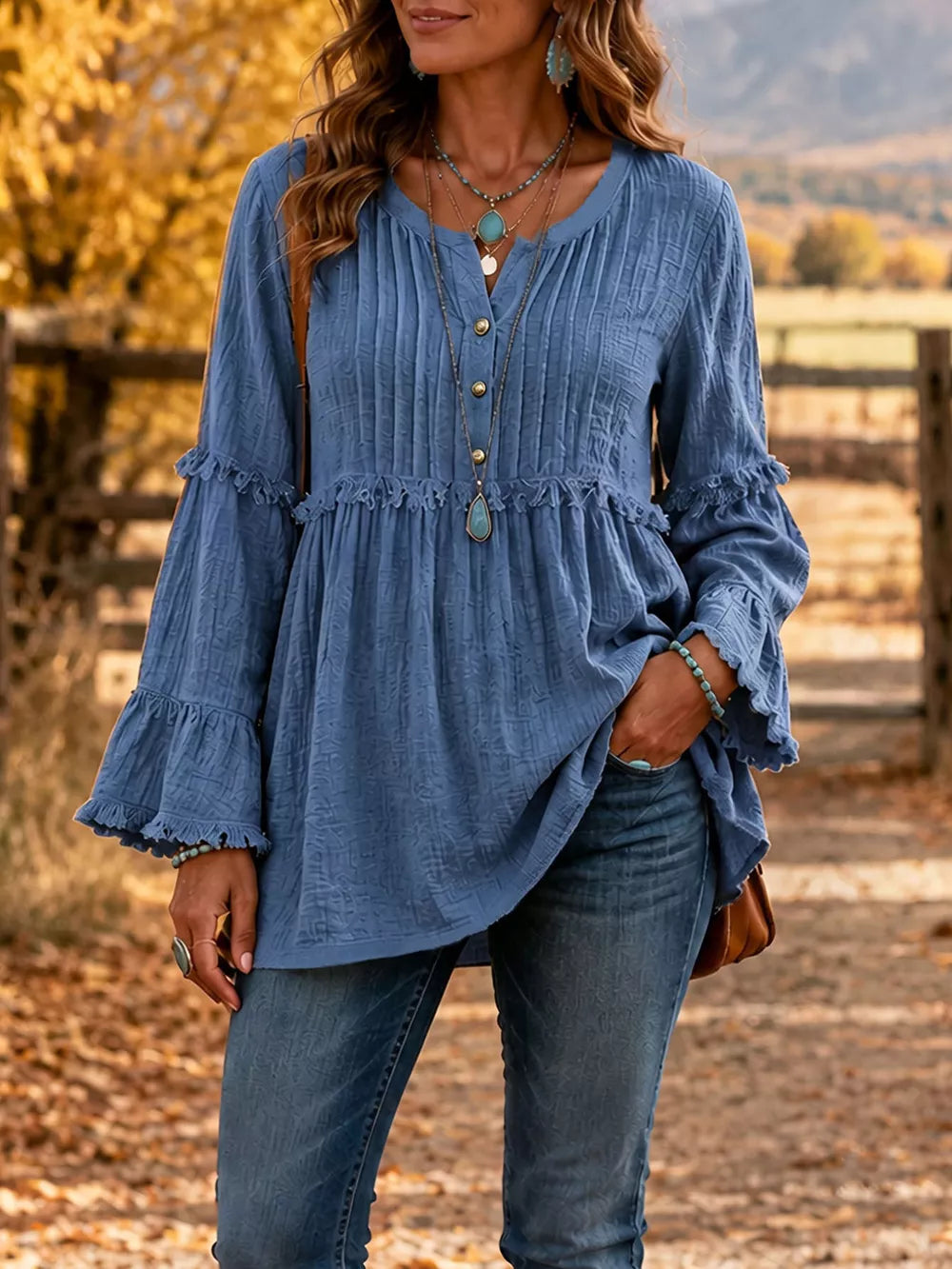 blouse in dusty blue featuring buttoned and relaxed fit