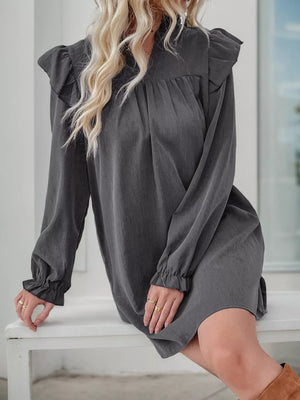 Dark gray ruffled notched sleeve dress with cinched cuffs and a gathered neckline.