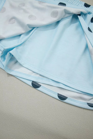 Pastel blue polka dot skort with elastic waistband and built-in shorts.