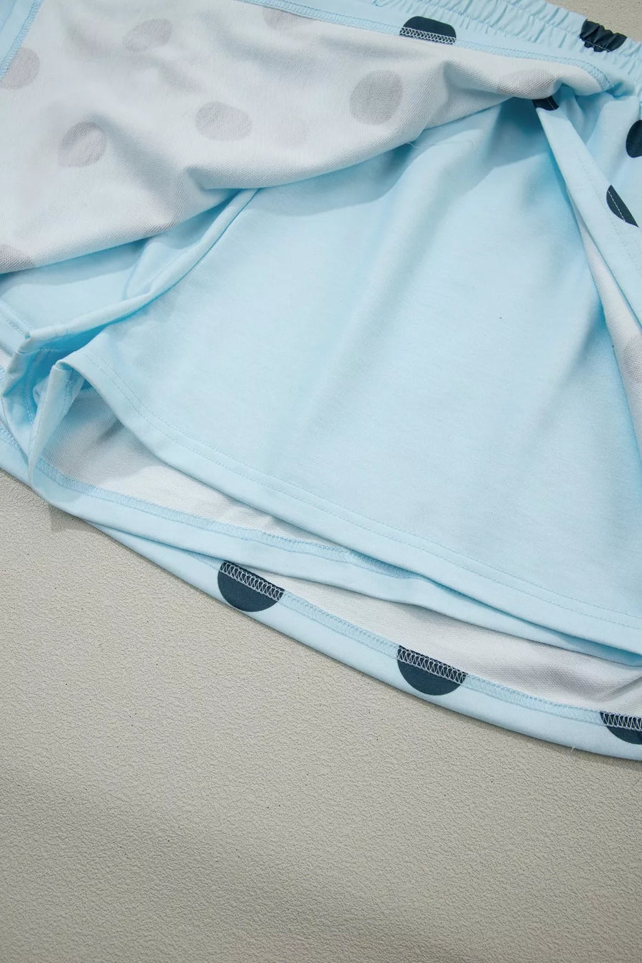 Pastel blue polka dot skort with elastic waistband and built-in shorts.