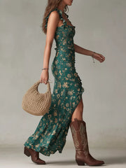 Dark green floral ruched maxi dress with ruffled straps and a high slit.