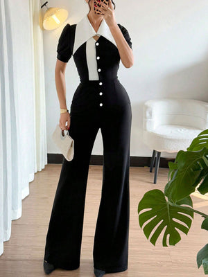 Button-down wide leg jumpsuit in black and white with a pointed collar and short sleeves.