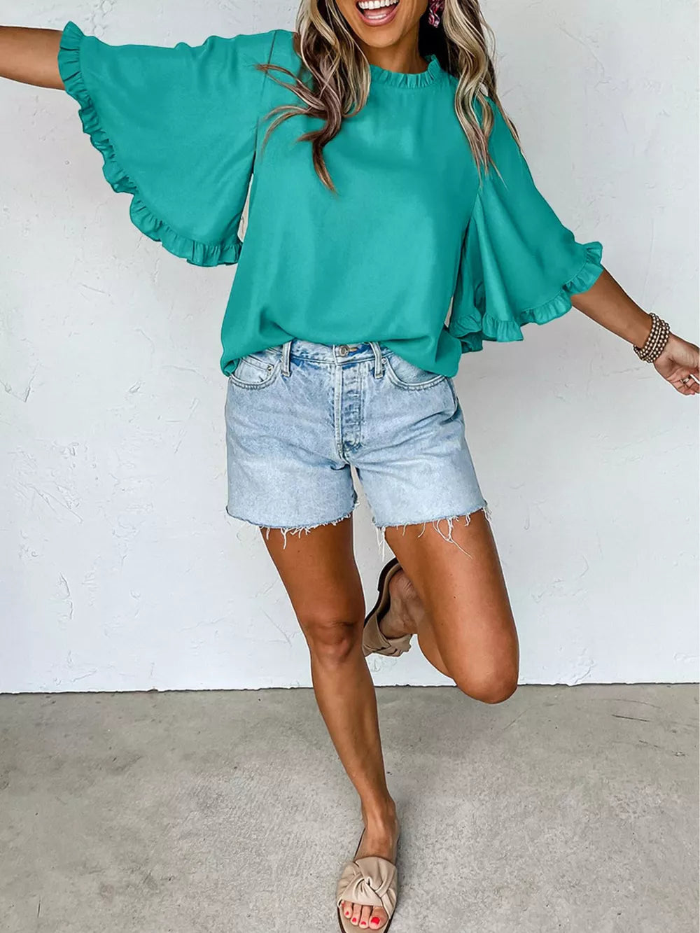 Teal ruffled mock neck half sleeve shirt with bell sleeves.
