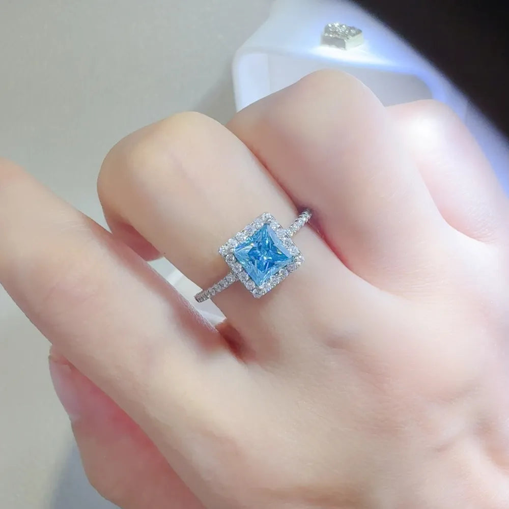 Silver ring with ice blue square halo diamond accent