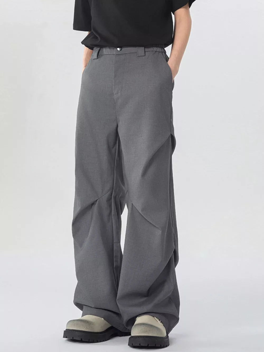 Dark gray oversized wide-leg cargo sweatpants with unique paneling detail.
