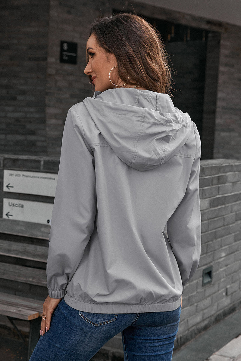 Light gray hooded utility jacket with drawstring waist and elastic cuffs.