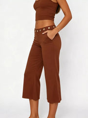Dark brown flared hem capri pants with button detail and pockets.