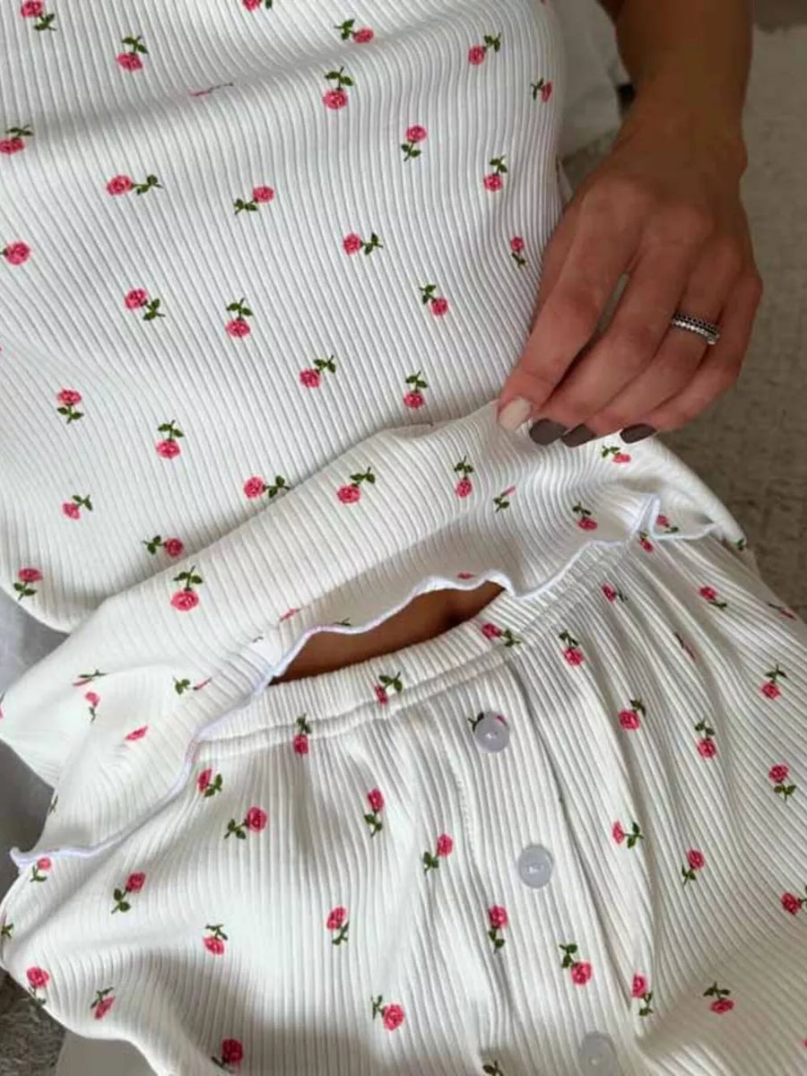 White ribbed cami and shorts set with a pink floral print and lettuce trim.