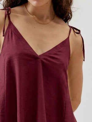 Burgundy camisole with adjustable tie straps and V-neckline.