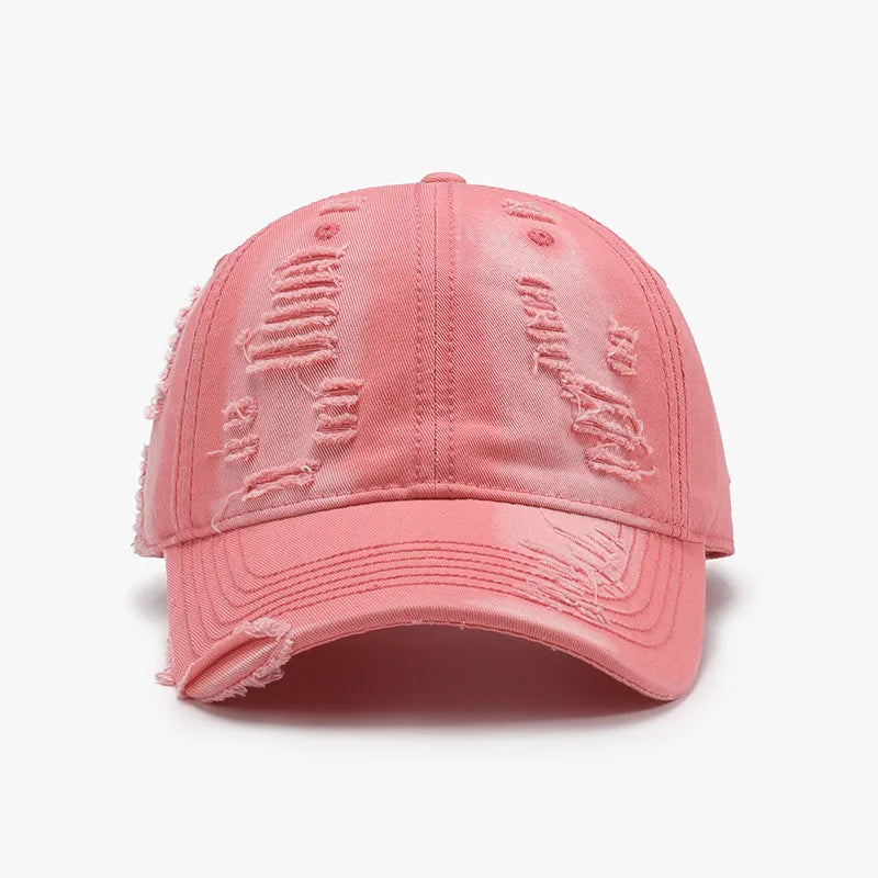 Distressed canvas baseball cap in burnt coral with ripped details.