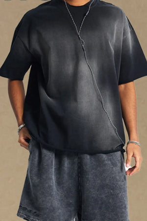 Black acid wash boxy tee with raw seam detail and short sleeves.