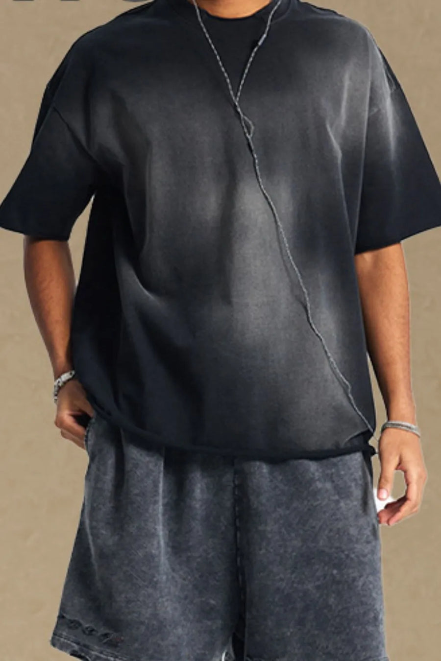 Black acid wash boxy tee with raw seam detail and short sleeves.