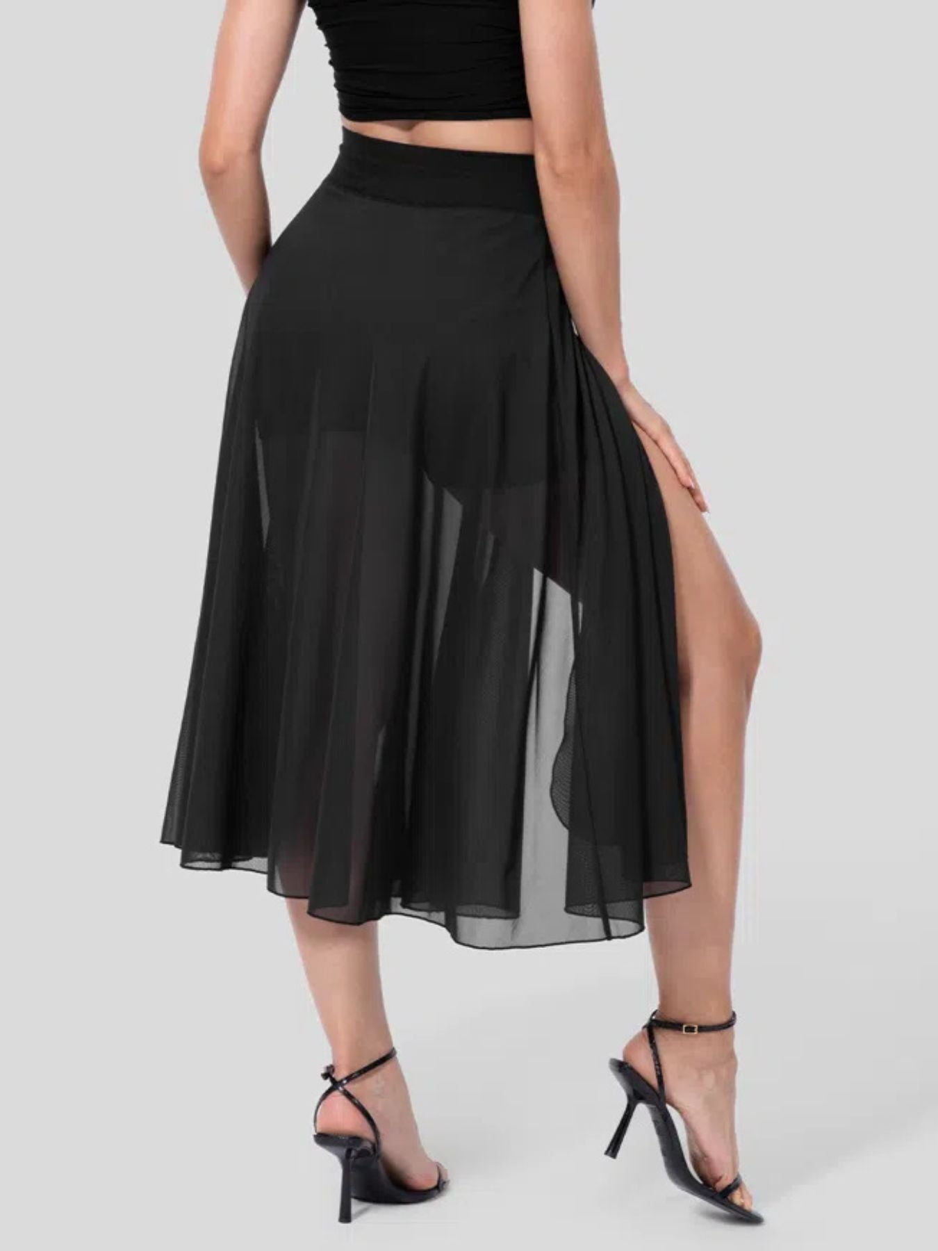 Black flowy midi skirt with shorts liner and high slit, featuring a drawstring waist.