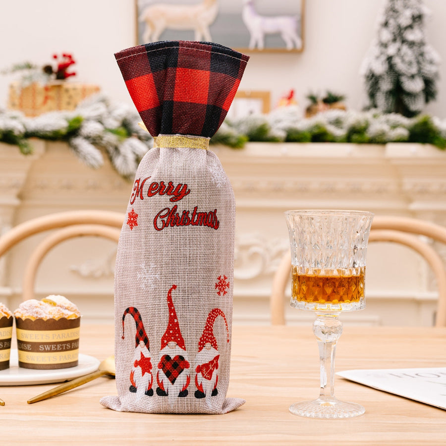 Festive gnome plaid bottle cover with Merry Christmas text and buffalo plaid top.