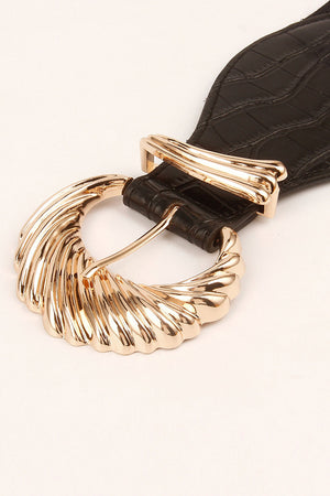 Black croc-embossed elastic belt with a sculptural gold buckle detail.