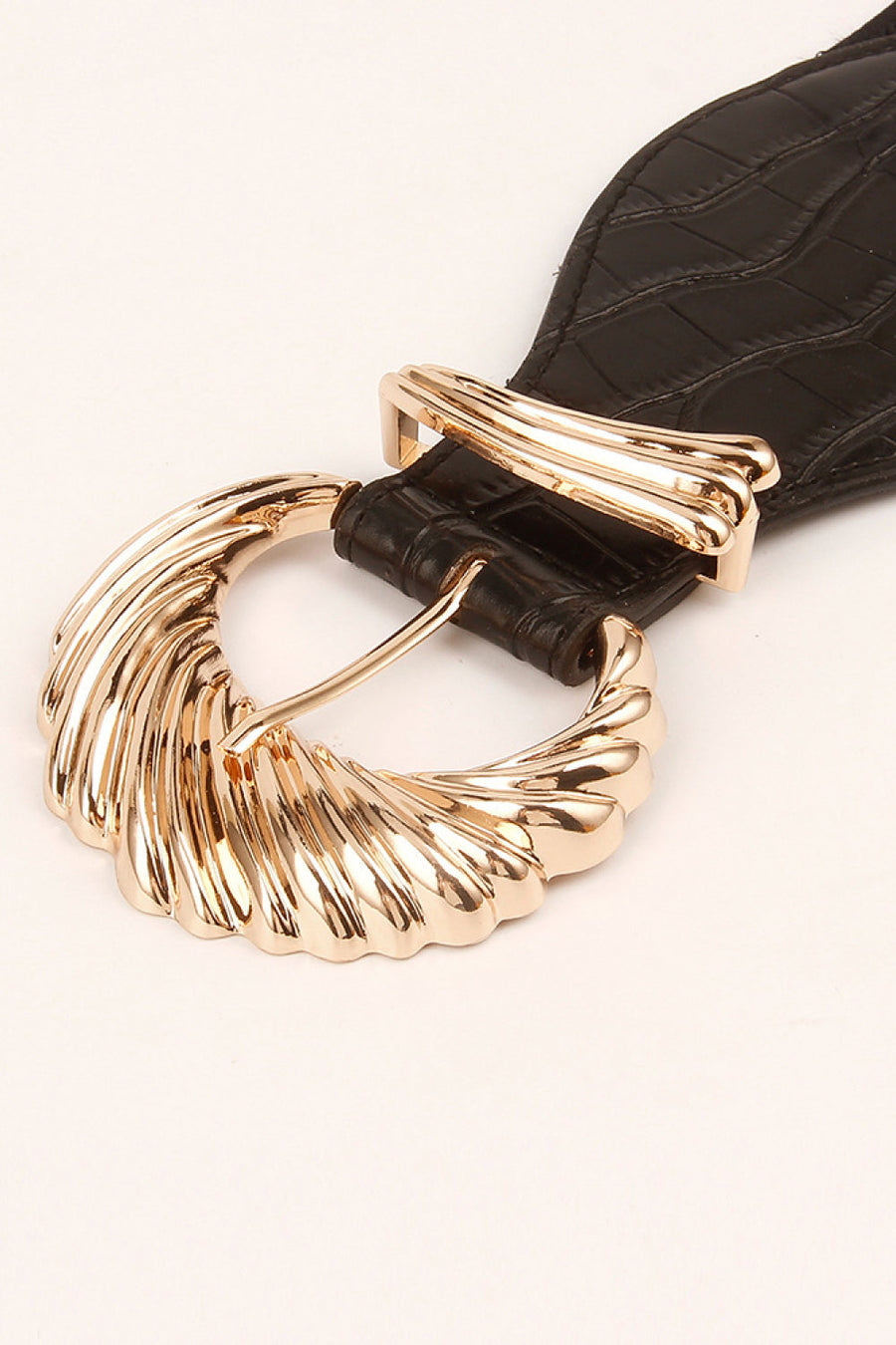 Black croc-embossed elastic belt with a sculptural gold buckle detail.