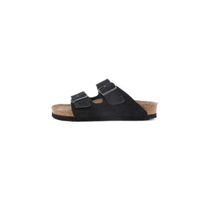 Black suede slide sandals with adjustable buckle straps and cork footbed.