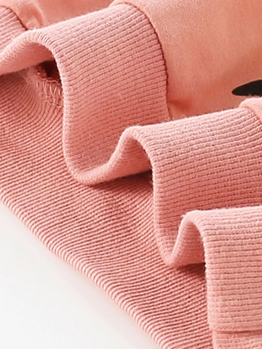 Dusty pink cotton sweatshirt with ribbed cuffs and hem, featuring a subtle owl graphic detail.