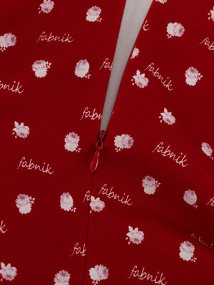 Red floral print dress with white text pattern and zipper detail