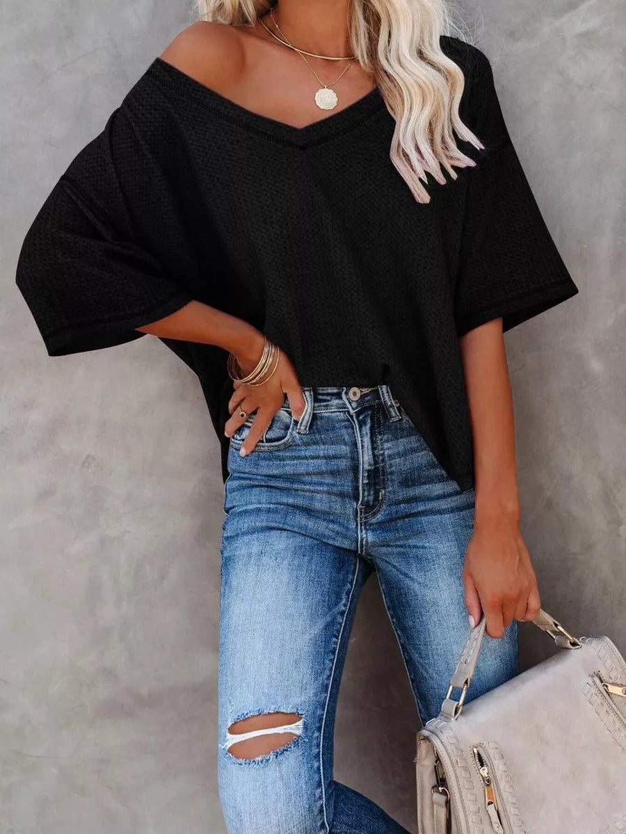 Black waffle knit relaxed v-neck t-shirt with short sleeves.