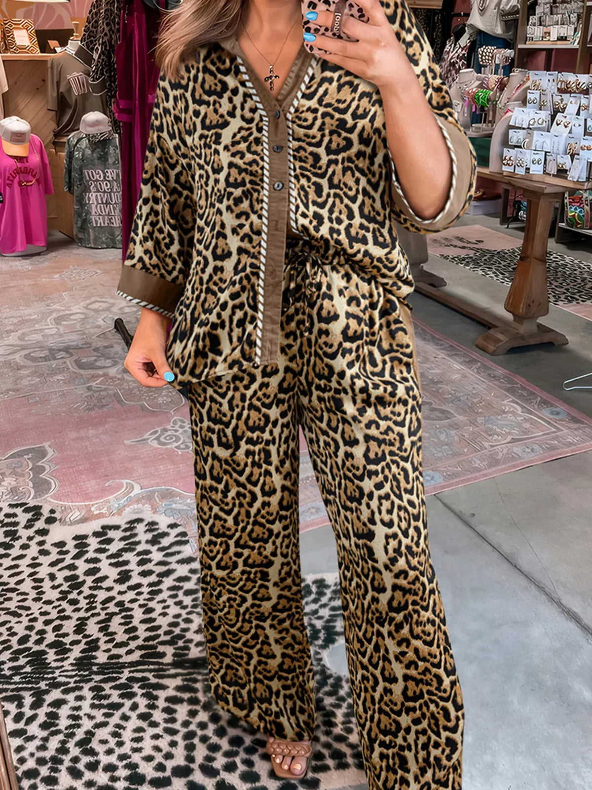 Leopard print two-piece set with buttoned shirt and wide-leg pants.