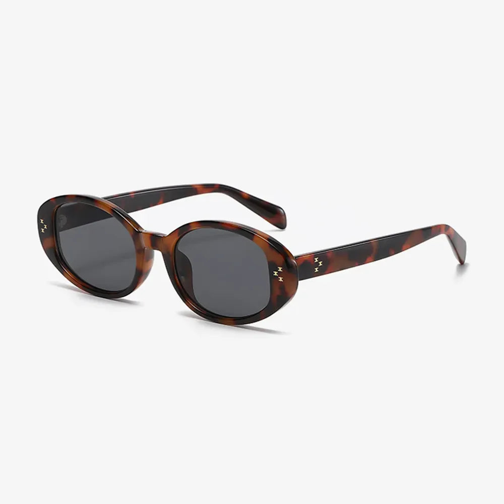 Tortoiseshell oval sunglasses with embellished details and dark lenses.