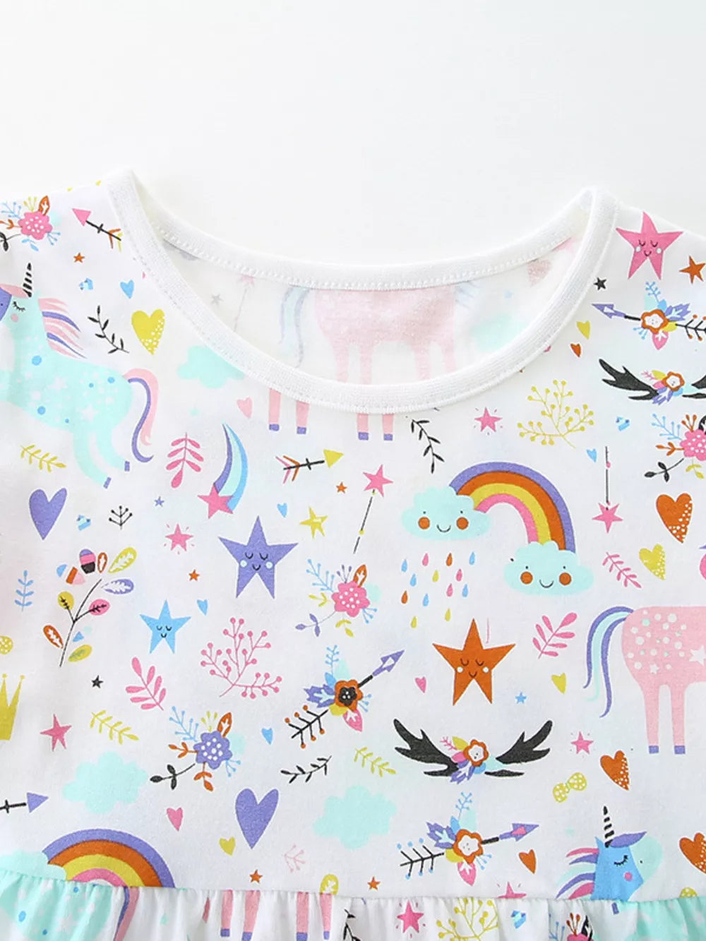 Toddler unicorn dress with rainbow, clouds, and stars print on white cotton.