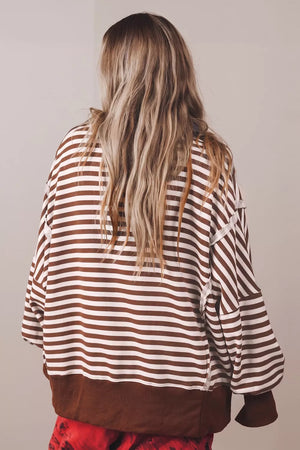white sweatshirt featuring buttoned and striped