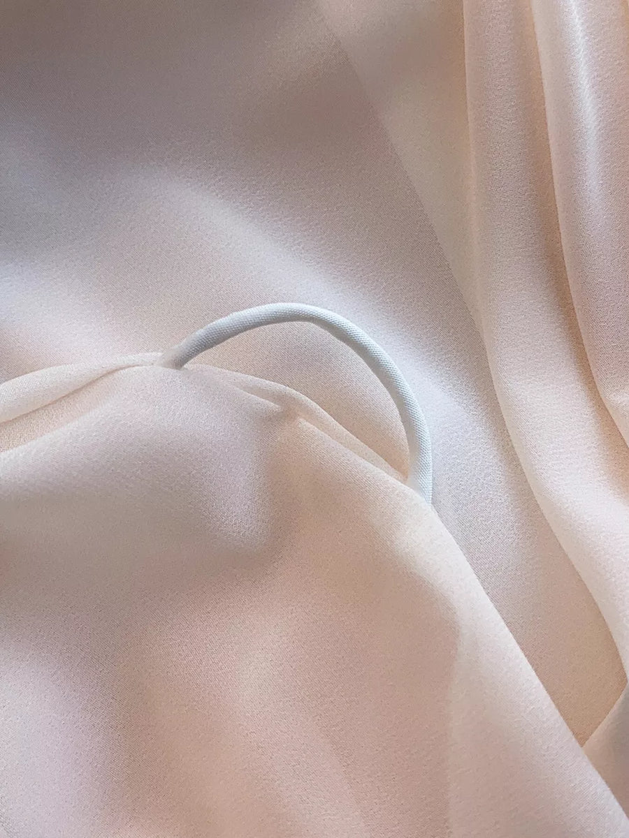 Light Pink off-shoulder dress detail with a white elastic strap.