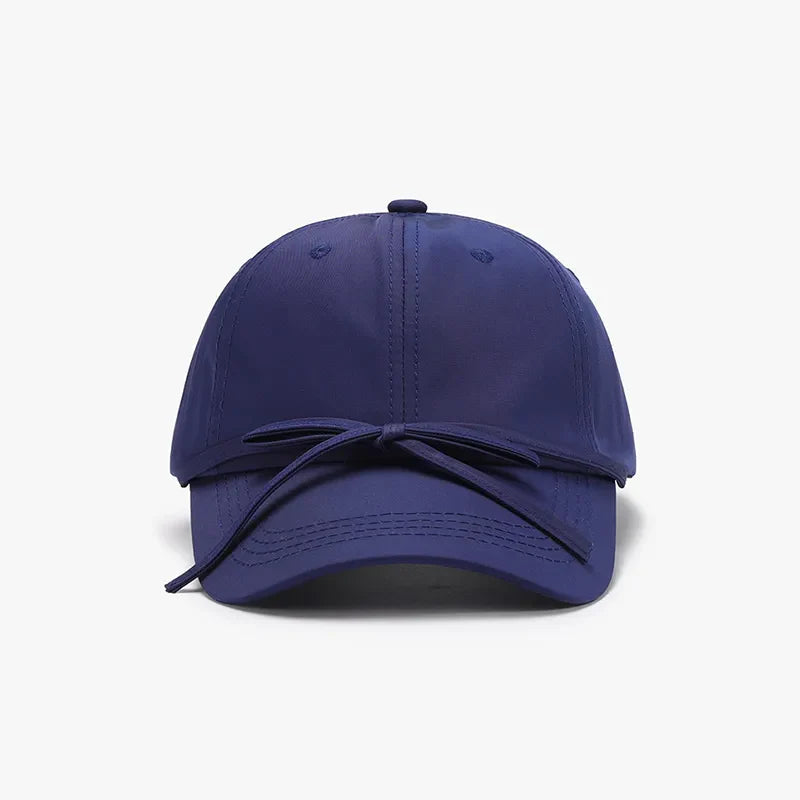 Navy baseball cap with a tied back bow detail