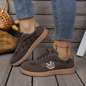 Brown round toe lace up sneakers with all over pattern and logo detail.