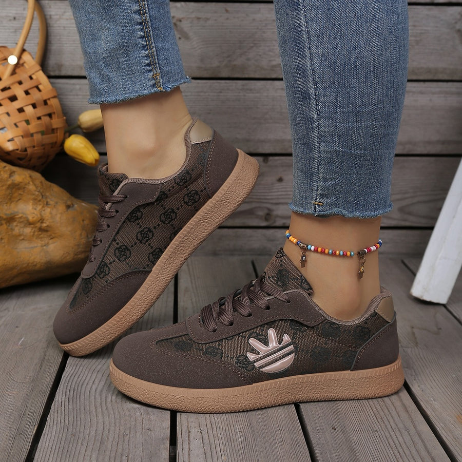 Brown round toe lace up sneakers with all over pattern and logo detail.