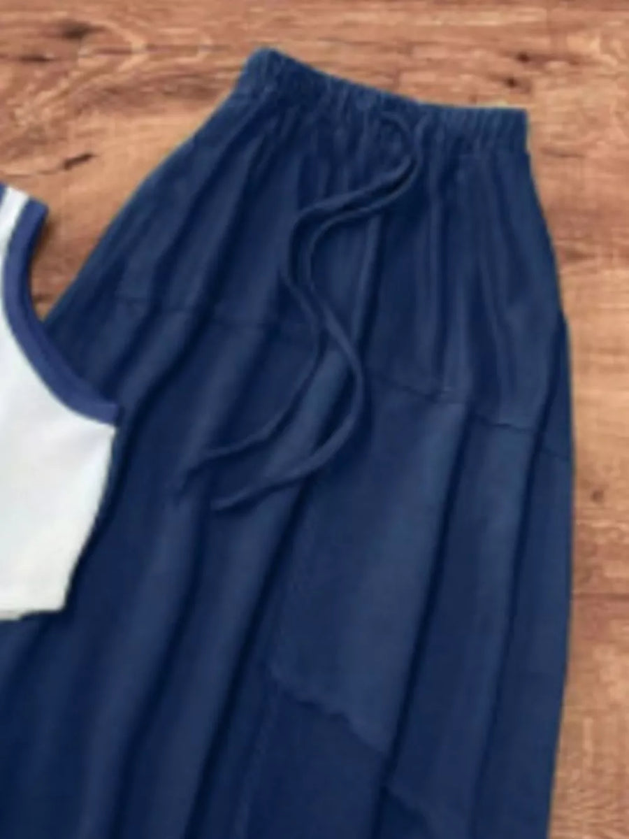 Navy blue flowy maxi skirt with drawstring waist and white trim tank top.