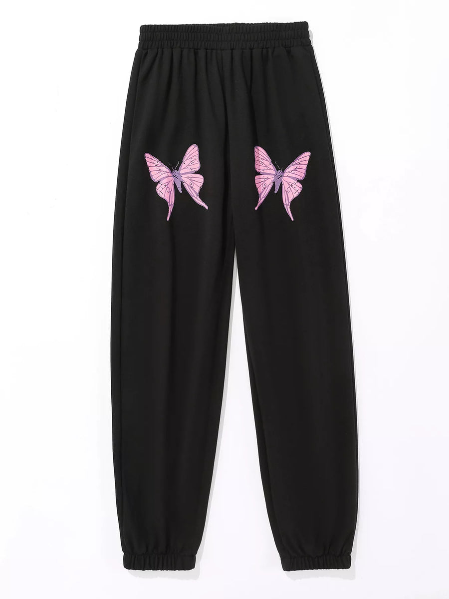 Black sweatpants with pink butterfly embellishments on the legs.