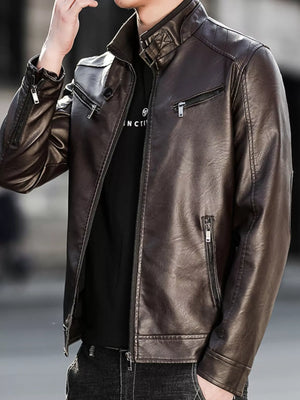 Men's brown leather zip-up jacket with multiple zippered pockets and quilted shoulder detail.